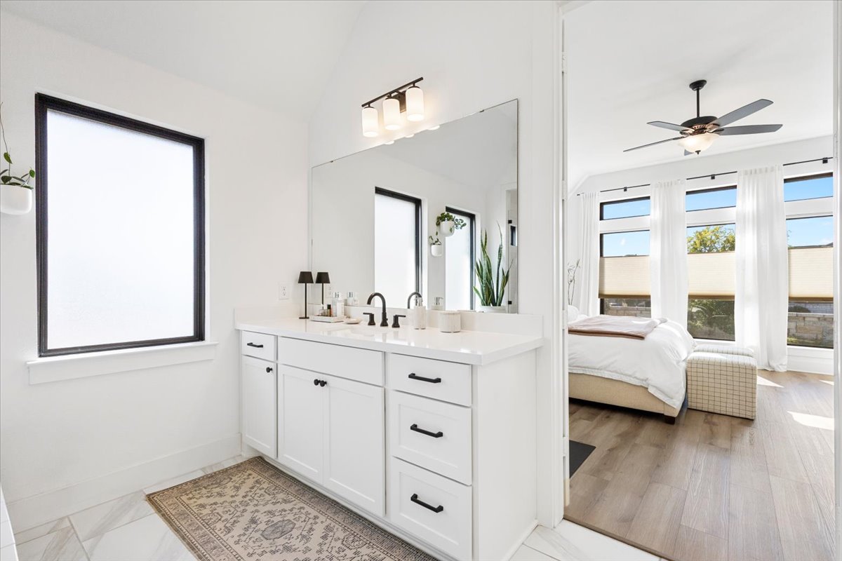 398 Trout River Road Kyle, TX 78640 - Photo 19 of 40 Full bathroom with vanity, lofted ceiling, ceiling fan, and connected bathroom