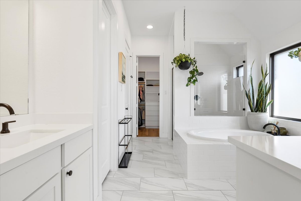 398 Trout River Road Kyle, TX 78640 - Photo 21 of 40 Full bath with a shower stall, vanity, a walk in closet, a garden tub, and recessed lighting