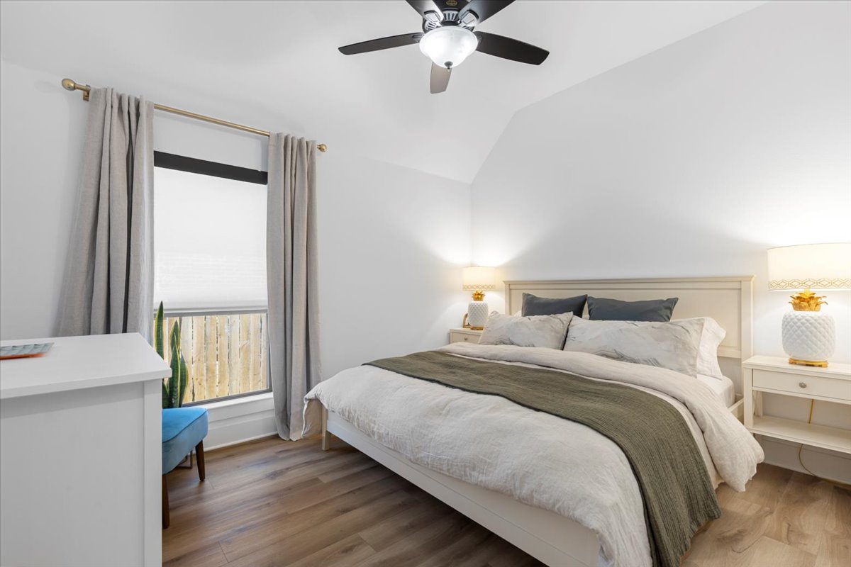 398 Trout River Road Kyle, TX 78640 - Photo 24 of 40 Bedroom with wood finished floors, vaulted ceiling, and a ceiling fan