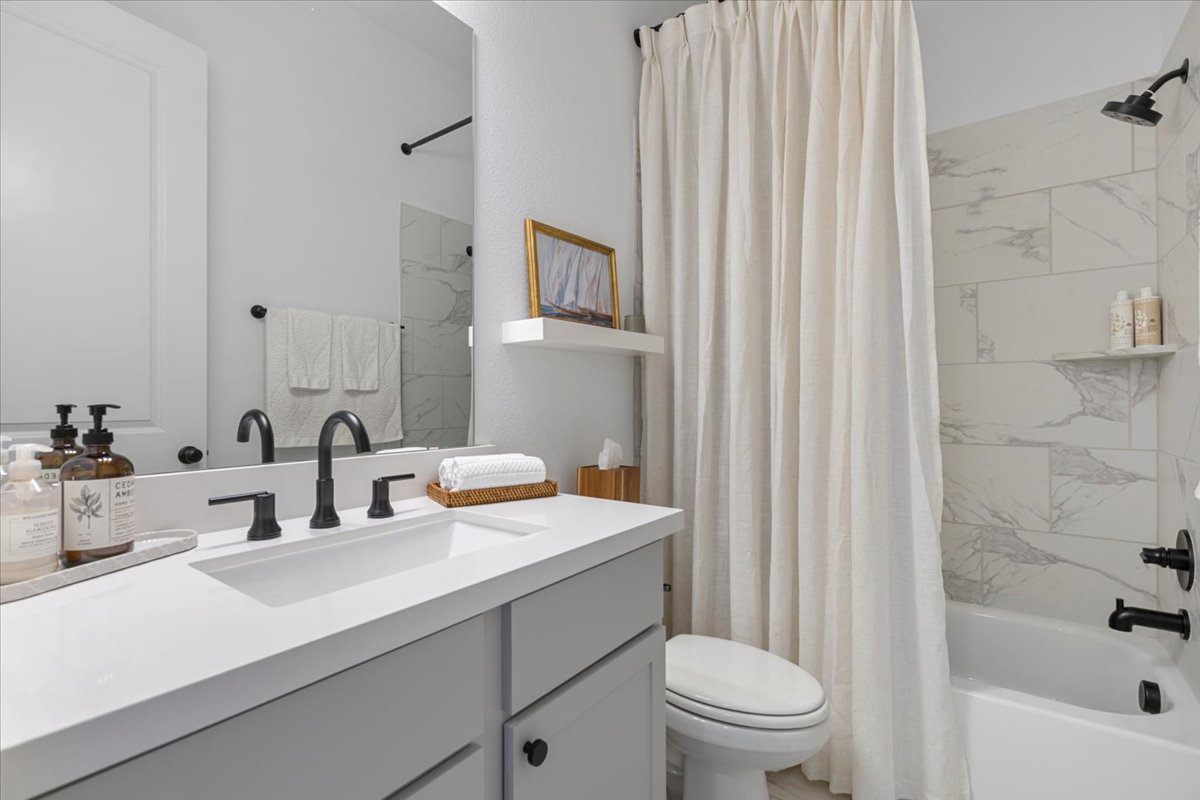 398 Trout River Road Kyle, TX 78640 - Photo 25 of 40 Full bath with vanity and shower / bath combo with shower curtain