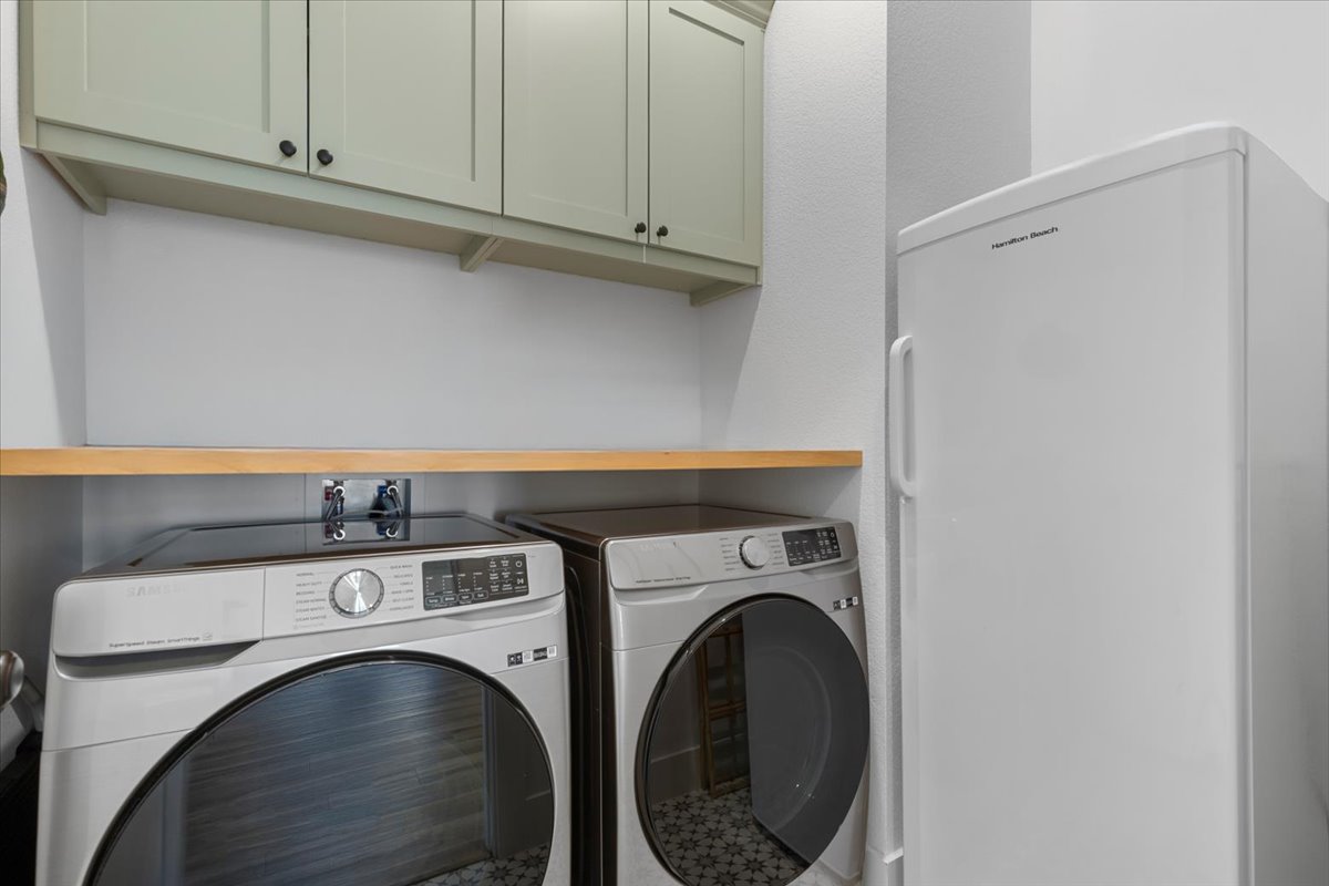398 Trout River Road Kyle, TX 78640 - Photo 29 of 40 Laundry room featuring cabinet space and independent washer and dryer