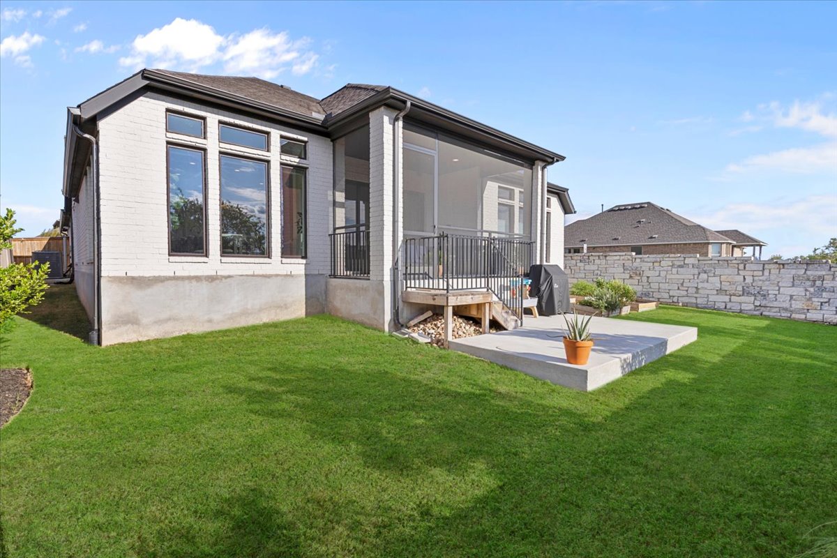 398 Trout River Road Kyle, TX 78640 - Photo 35 of 40 Rear view of property featuring a sunroom and brick siding