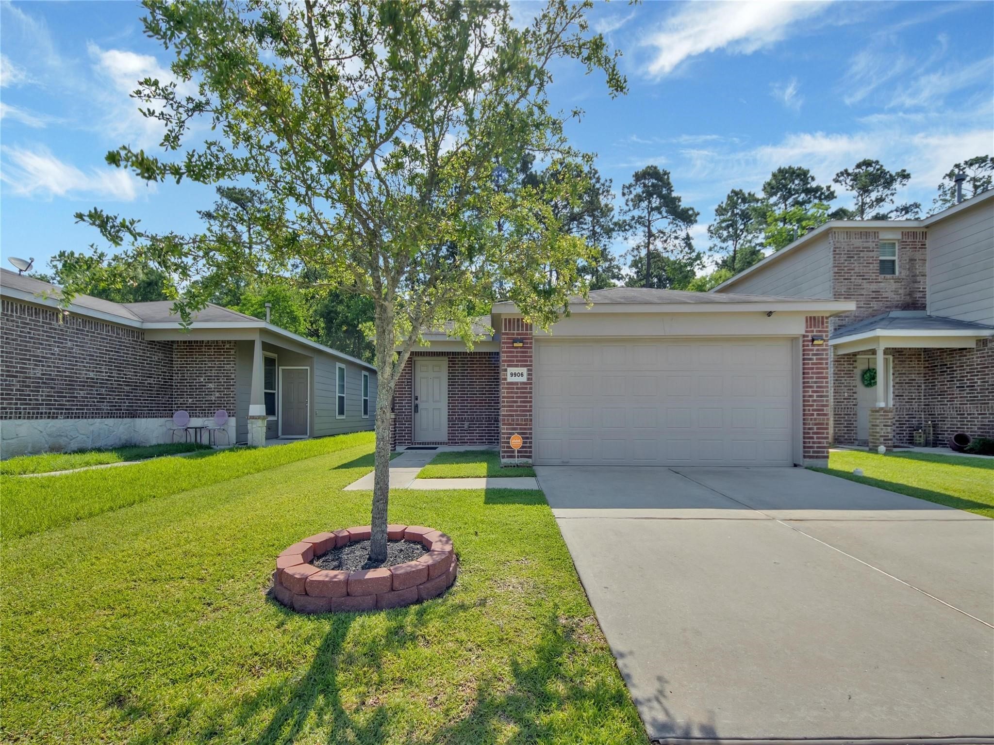 9906 Orchid Spring Lane Houston, TX 77044 - Photo 1 of 27 a front view of a house with a yard and entertaining space