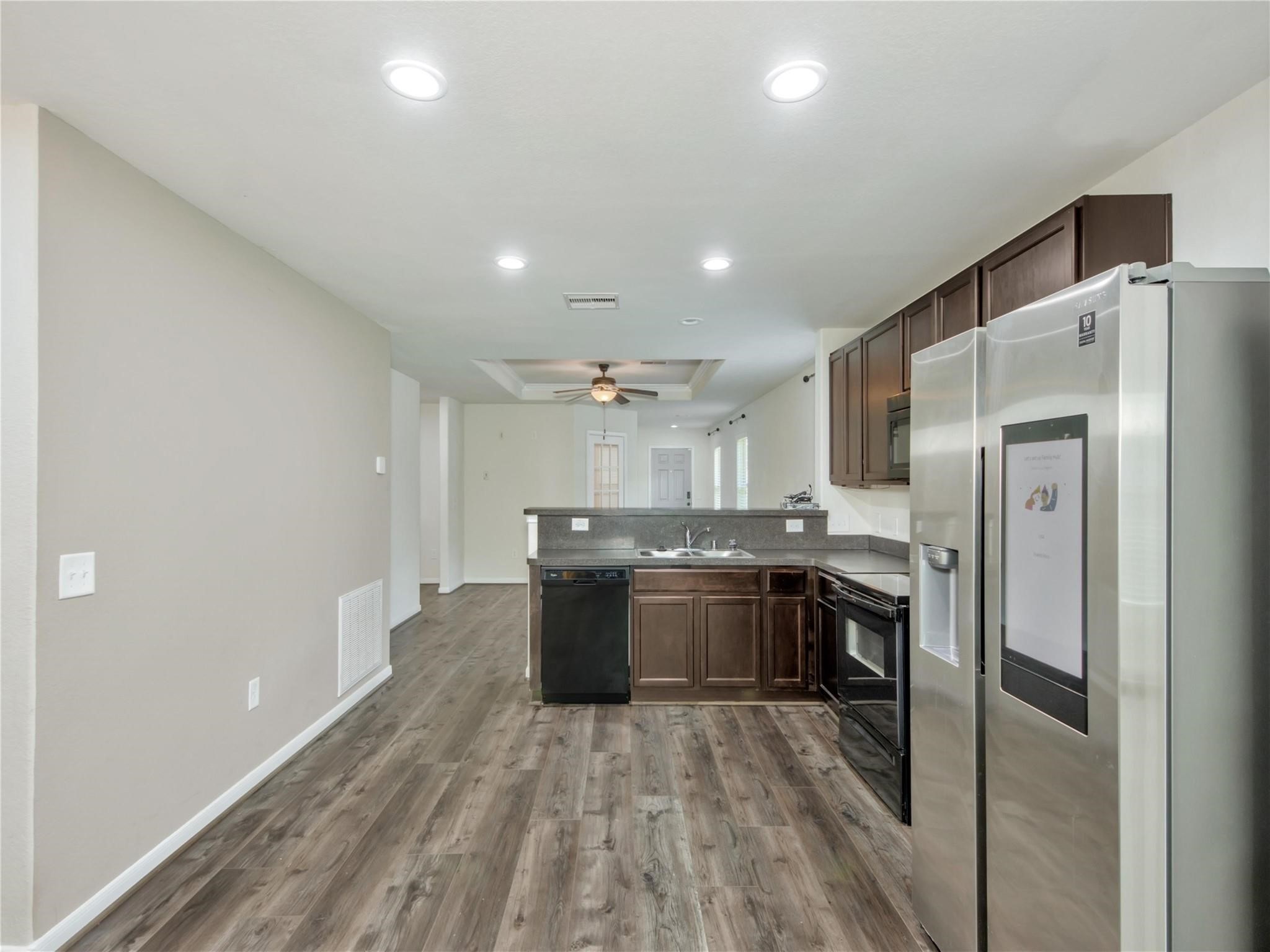 9906 Orchid Spring Lane Houston, TX 77044 - Photo 11 of 27 a kitchen with stainless steel appliances granite countertop a refrigerator and a stove top oven