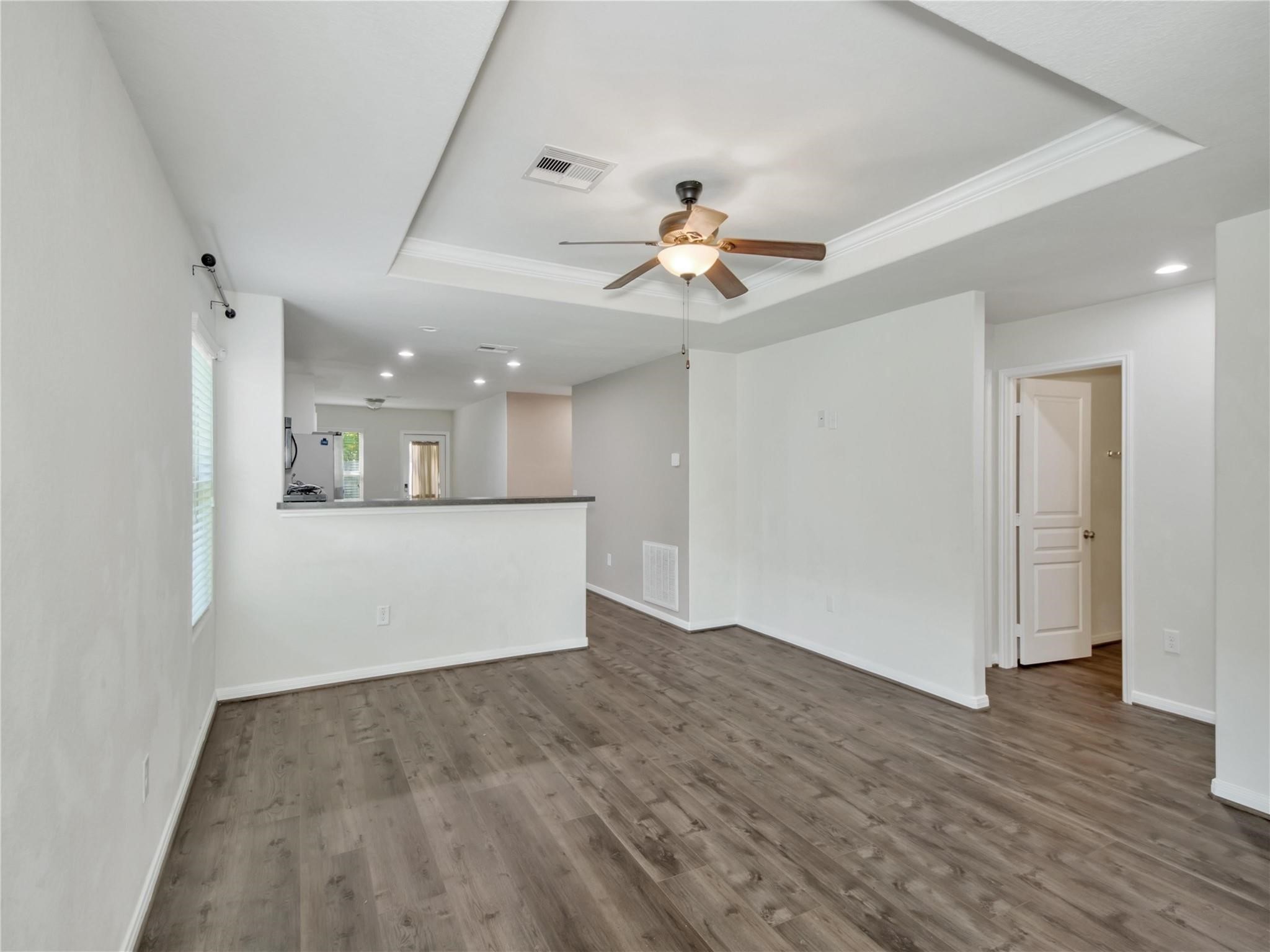 9906 Orchid Spring Lane Houston, TX 77044 - Photo 12 of 27 a view of a kitchen with a sink and wooden floor