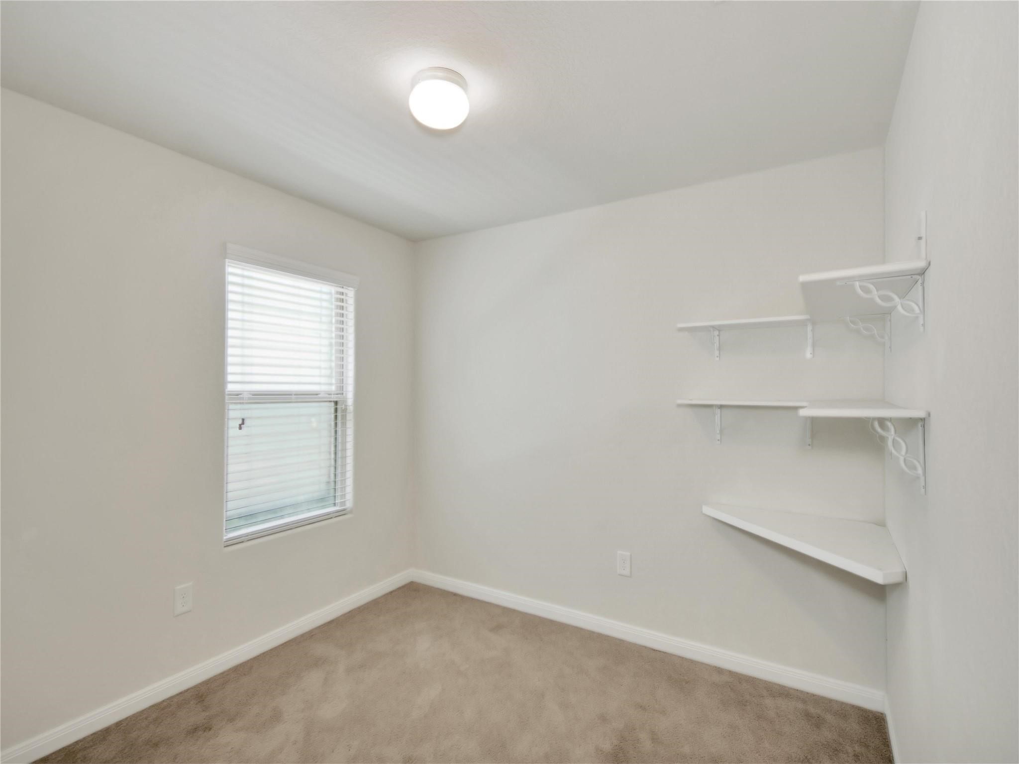 9906 Orchid Spring Lane Houston, TX 77044 - Photo 18 of 27 an empty room with windows