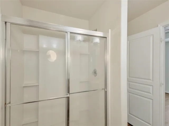 a bathroom with a glass shower door
