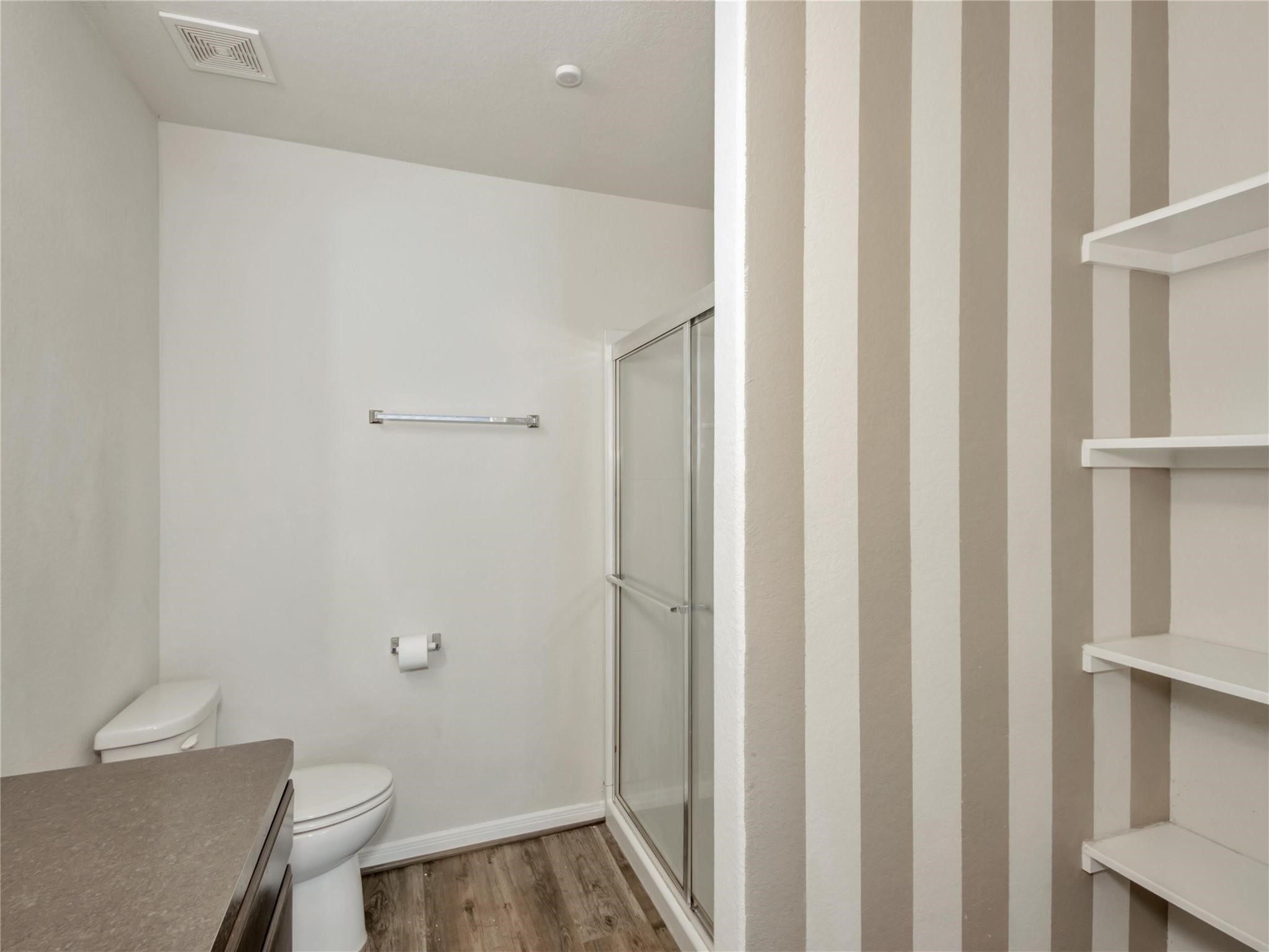 9906 Orchid Spring Lane Houston, TX 77044 - Photo 21 of 27 a bathroom with a toilet and a shower