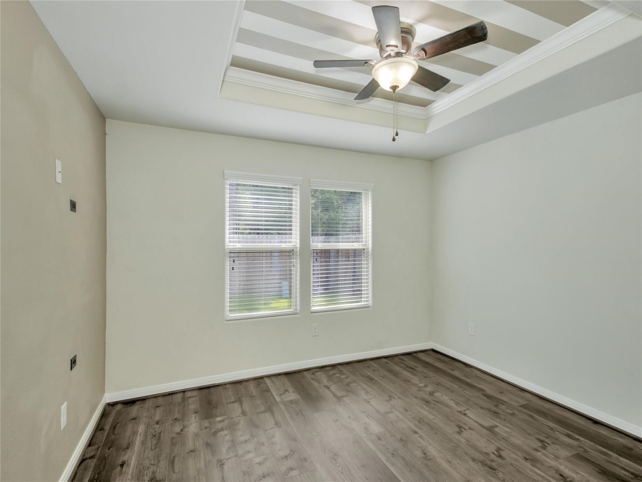 9906 Orchid Spring Lane Houston, TX 77044 - Photo 25 of 27 an empty room with a window and a ceiling fan