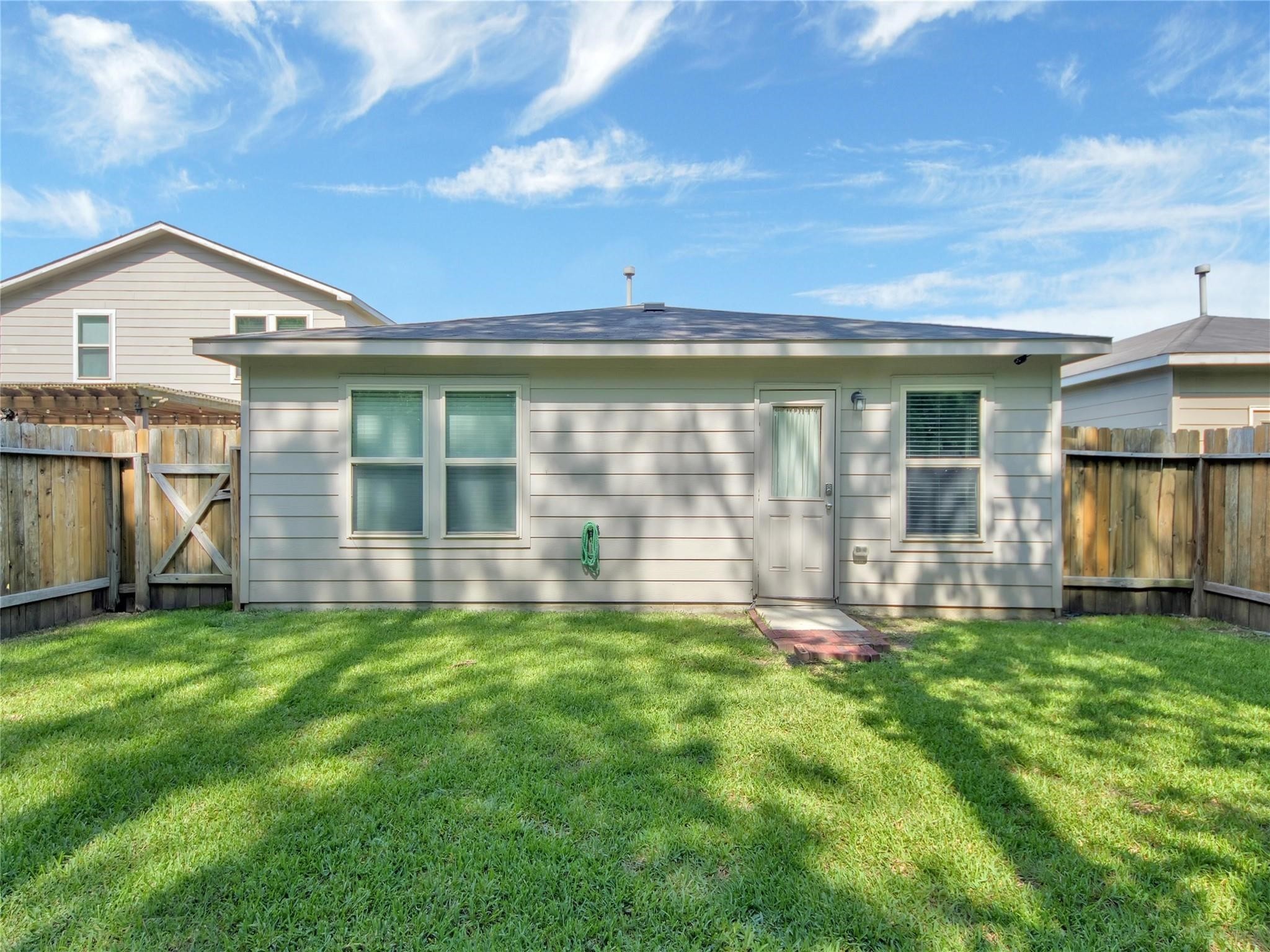 9906 Orchid Spring Lane Houston, TX 77044 - Photo 27 of 27 a view of a house with a yard and sitting area