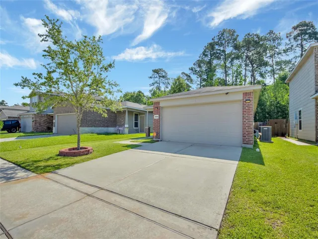 a front view of a house with a yard and a garage