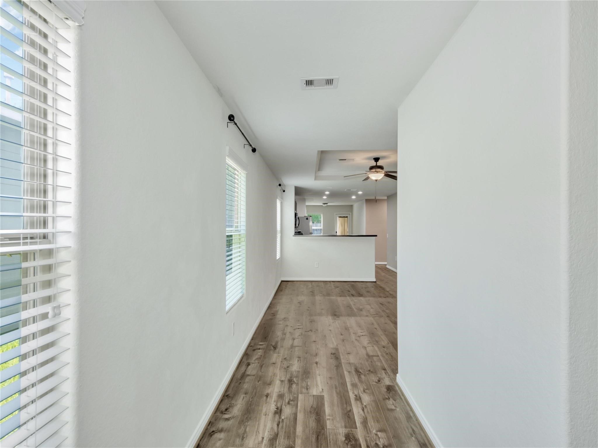 9906 Orchid Spring Lane Houston, TX 77044 - Photo 5 of 27 a view of a hallway view with wooden floor and staircase