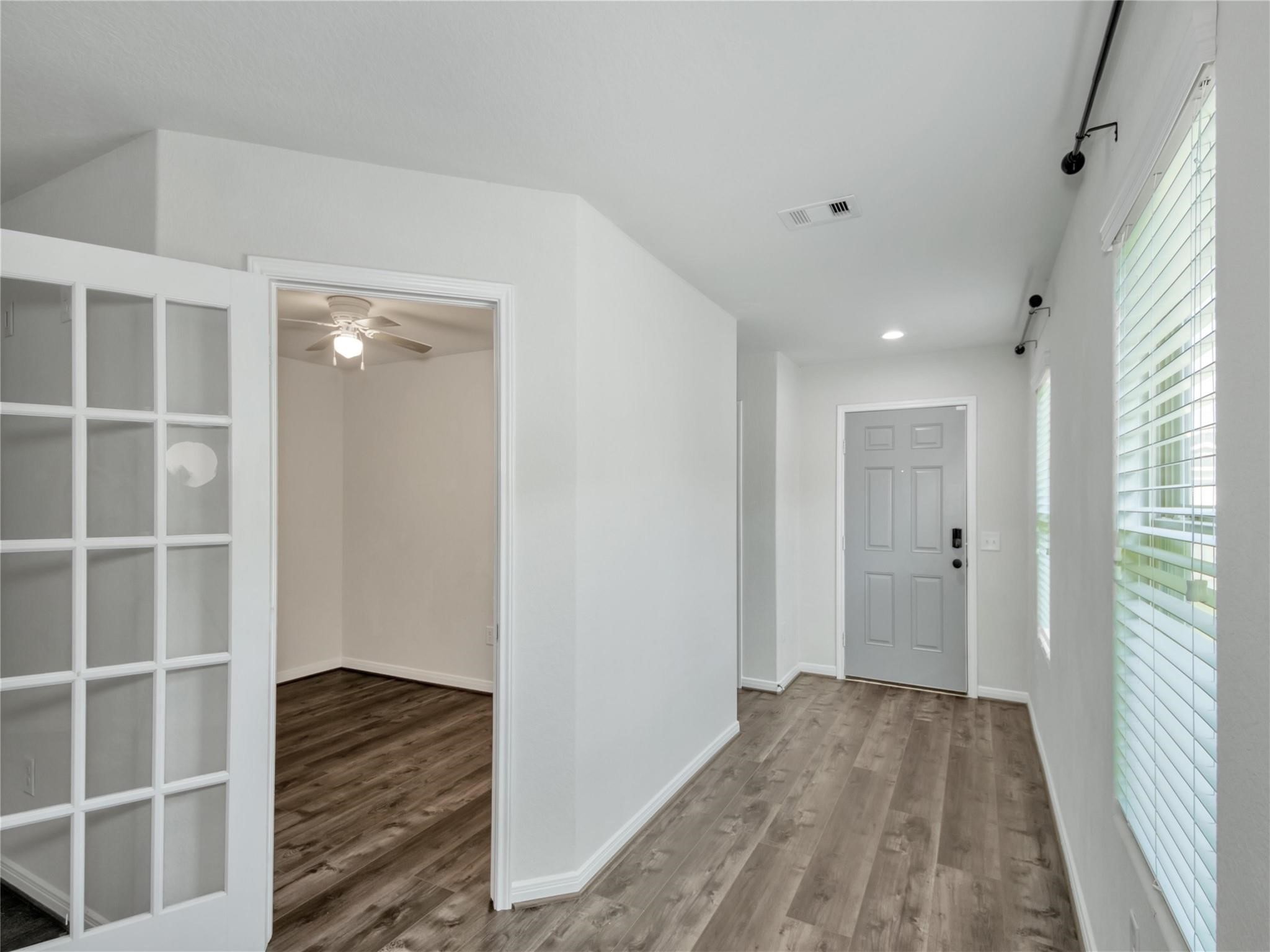 9906 Orchid Spring Lane Houston, TX 77044 - Photo 6 of 27 a view of a hallway with wooden floor and closet
