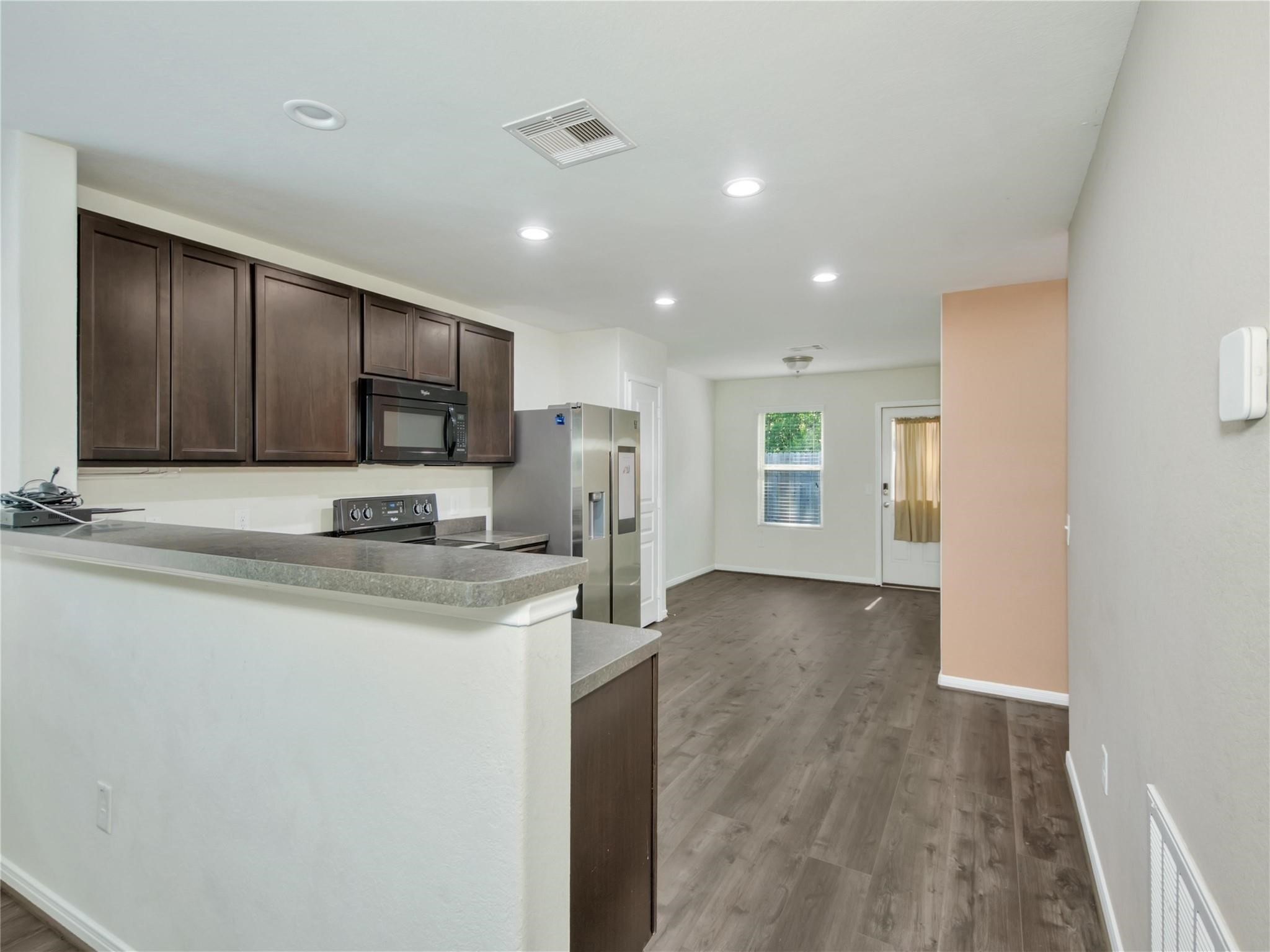 9906 Orchid Spring Lane Houston, TX 77044 - Photo 10 of 27 a view of a kitchen with stainless steel appliances granite countertop a sink and cabinets