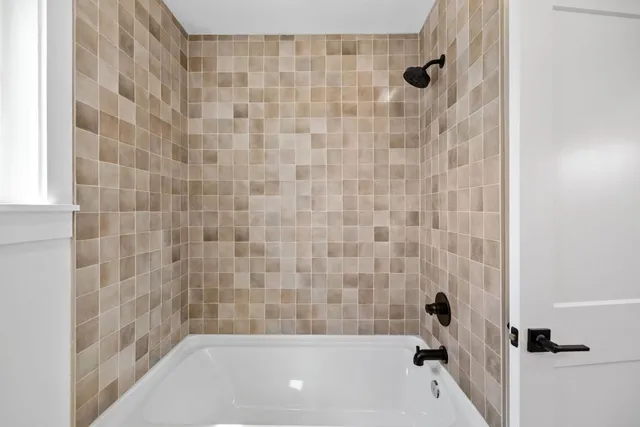 a bathroom with a granite countertop sink mirror vanity and toilet