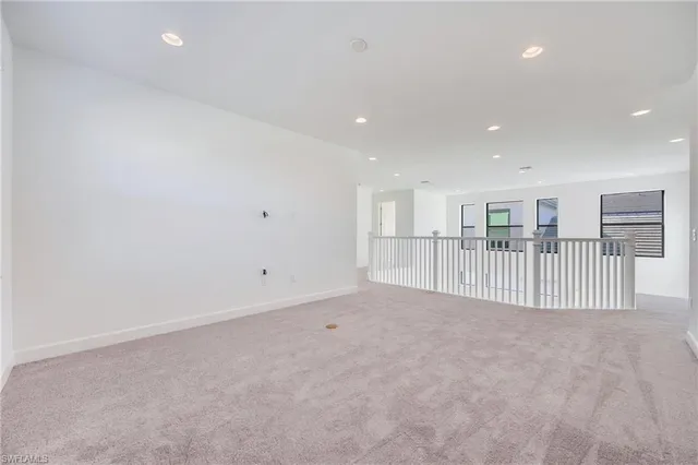 a view of a livingroom with entryway & windows