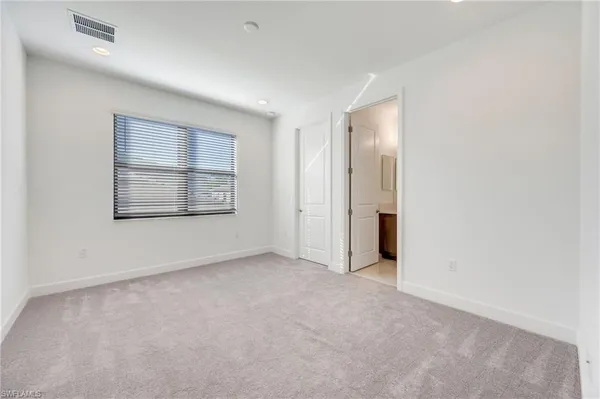 an empty room with a empty space and windows