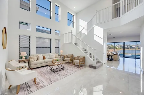 a living room with furniture and large windows
