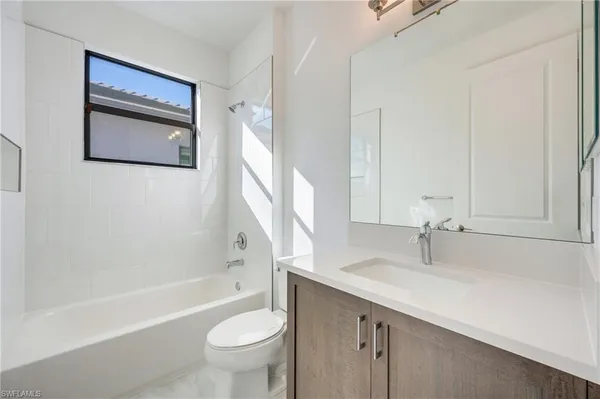 a bathroom with a sink a toilet and a bathtub