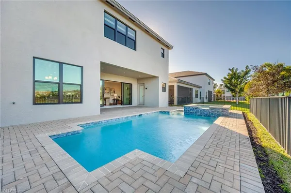 a view of a house with backyard and sitting area