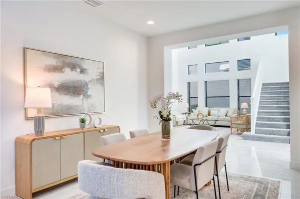 a dining room with furniture and window