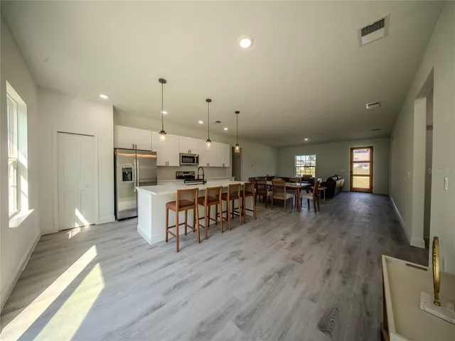 a room with lots of wooden furniture and a large window