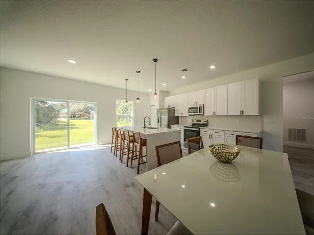 a kitchen with counter top space cabinets and appliances
