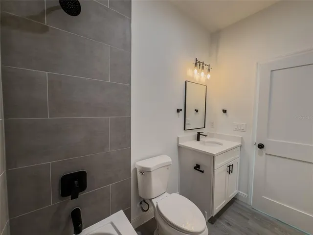 a bathroom with a toilet a sink and mirror