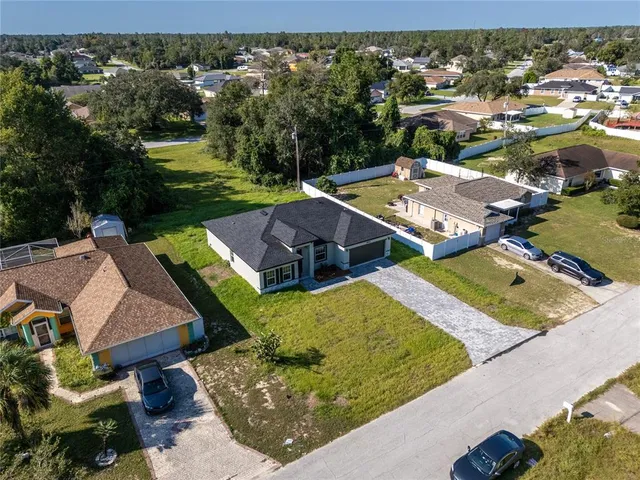 an aerial view of a house with garden space and street view