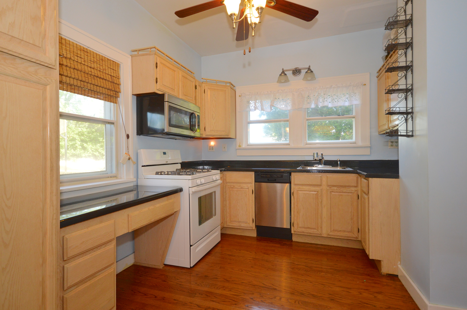 1038 Ferndale Street Gurnee, IL 60031 - Photo 8 of 17 a kitchen with stainless steel appliances granite countertop a stove a sink and a microwave