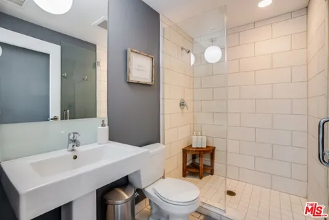 a bedroom with a large bed and a potted plant