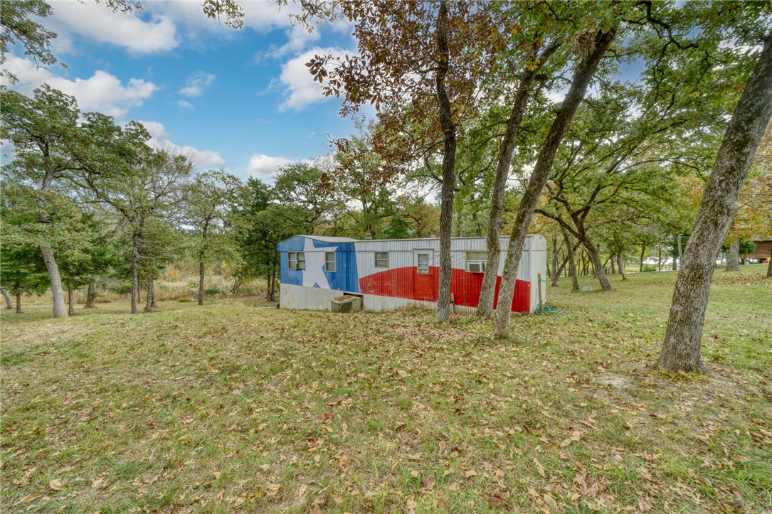 10232 Riley Green Road Franklin, TX 77856 - Photo 12 of 40 View of grassy yard with an outdoor structure