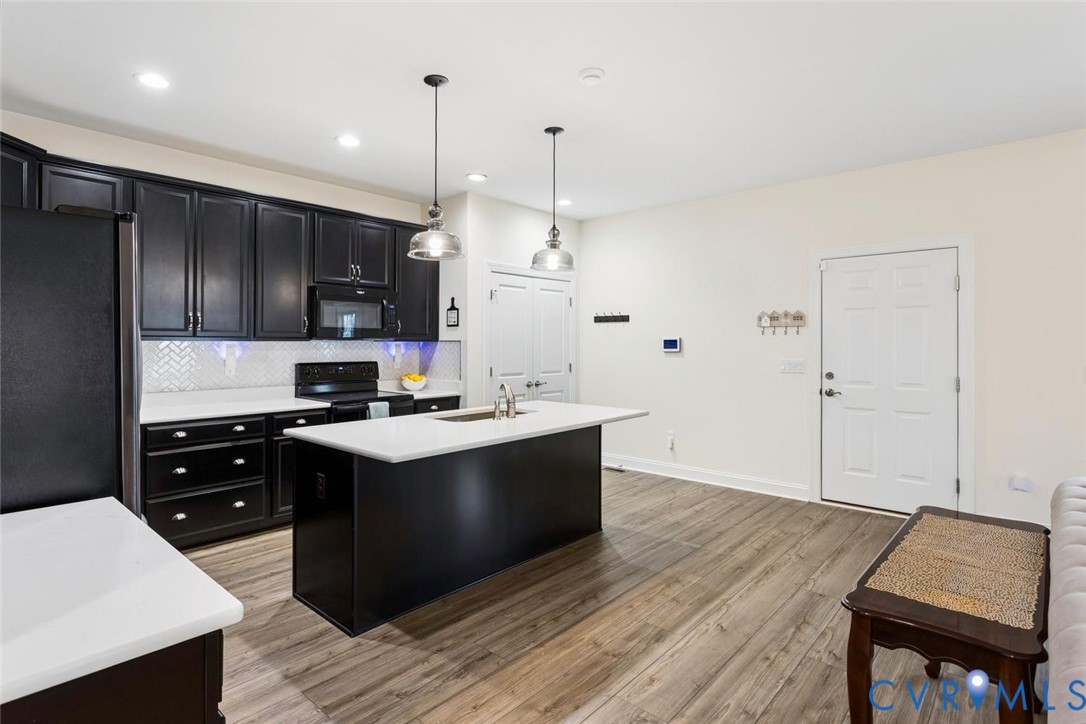 212 Lauradell Road Ashland, VA 23005 - Photo 23 of 35 a kitchen with kitchen island a sink dishwasher a stove and a refrigerator with wooden floor
