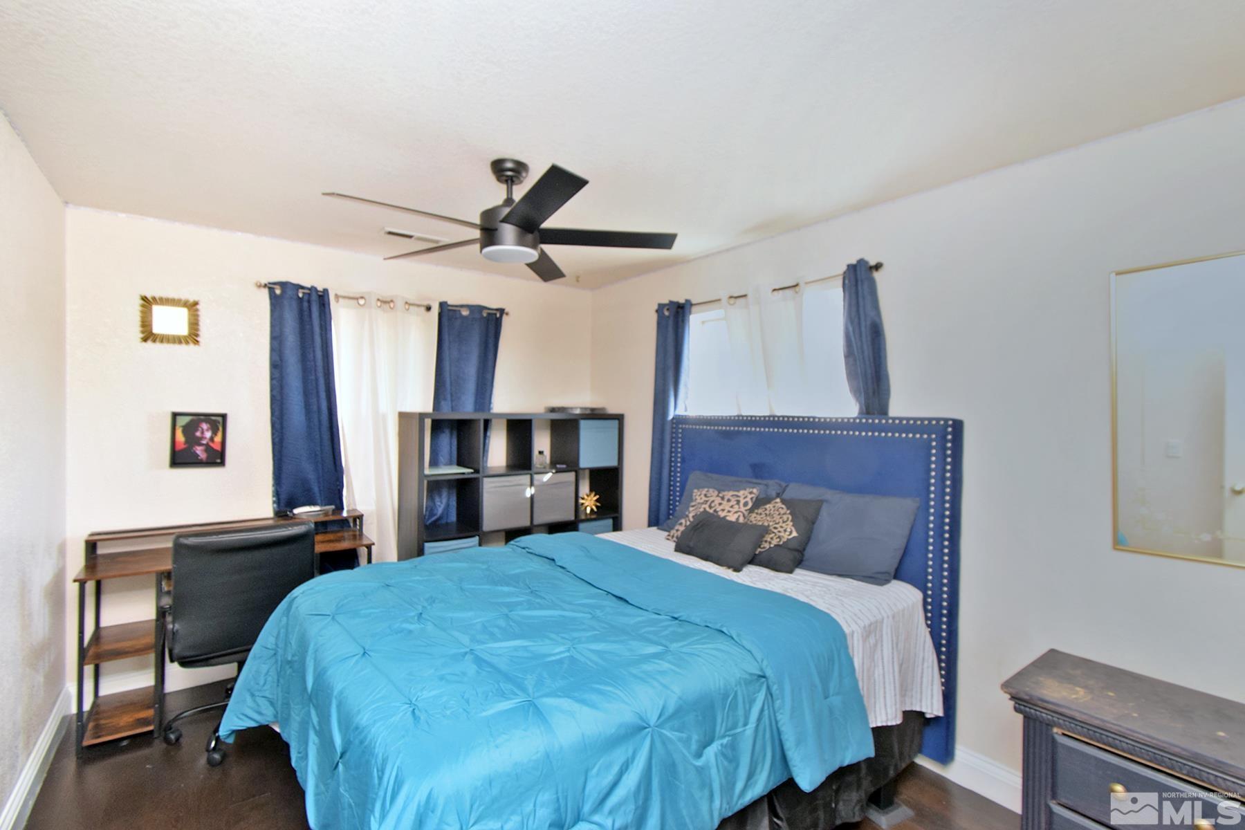 902 Vine Street Reno, NV 89503 - Photo 18 of 20 a bedroom with a bed and a chandelier
