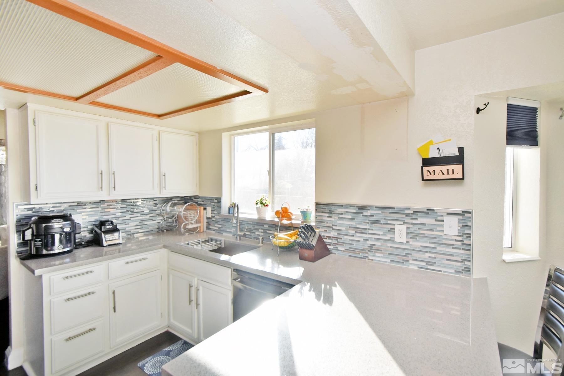 902 Vine Street Reno, NV 89503 - Photo 9 of 20 a kitchen with a sink cabinets and window