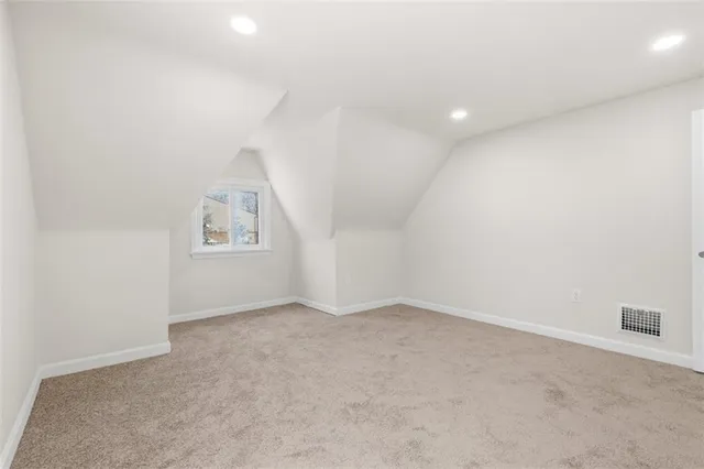 an empty room with a empty space and windows