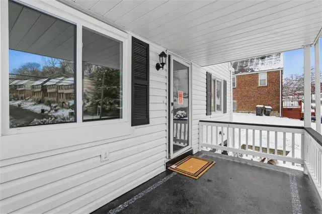 a view of staircase with furniture and front door