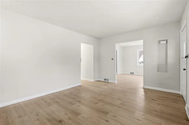 a view of an empty room and wooden floor