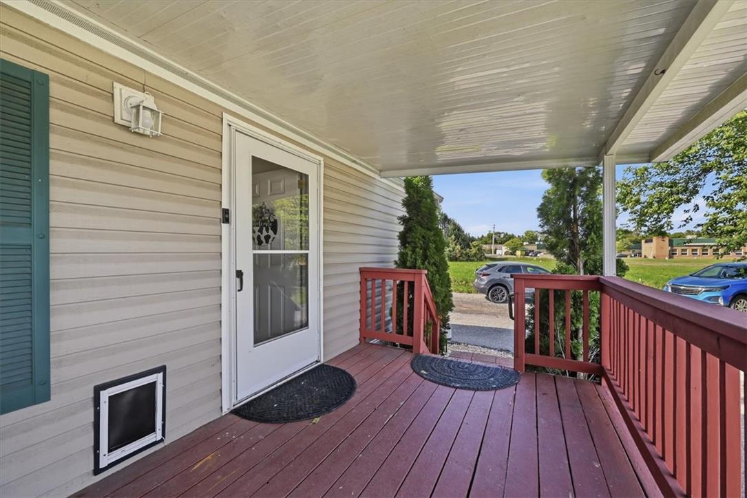 6129 Memorial Road Allentown, PA 18104 - Photo 10 of 46 An inviting covered deck entry showcases durable horizontal siding and classic wooden railings.