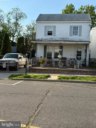 a view of house with swimming pool and a yard