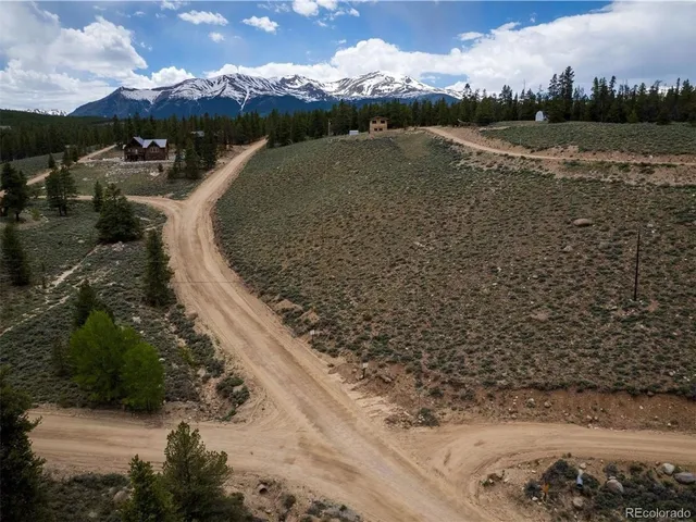a view of a yard with wooden fence