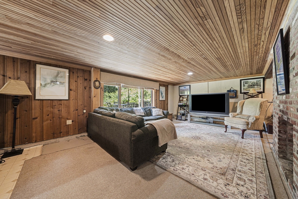 639 Main Street Hingham, MA 02043 - Photo 23 of 41 a living room with furniture a flat screen tv and a large window