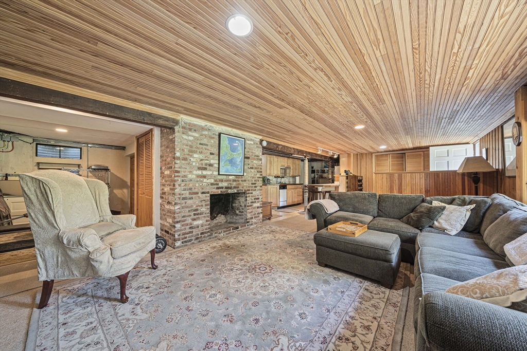 639 Main Street Hingham, MA 02043 - Photo 24 of 41 a living room with furniture a fireplace and a table