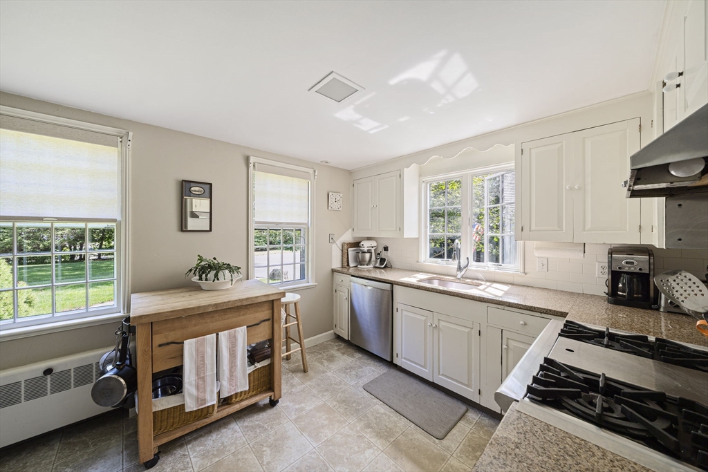 639 Main Street Hingham, MA 02043 - Photo 4 of 41 a kitchen that has a lot of cabinets in it and wooden floors