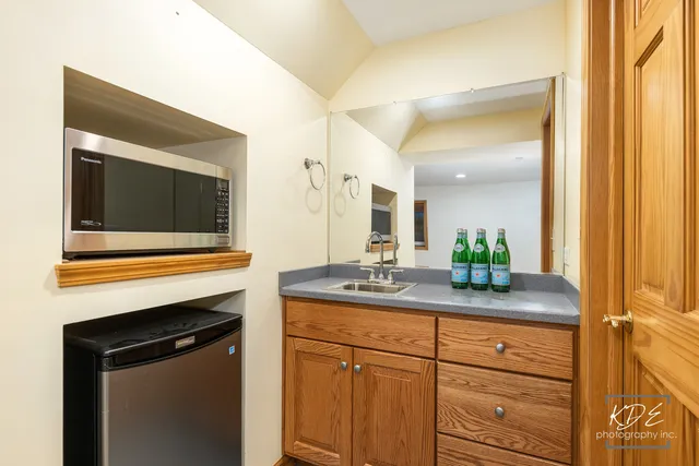 a bathroom with a sink toilet a mirror and shower