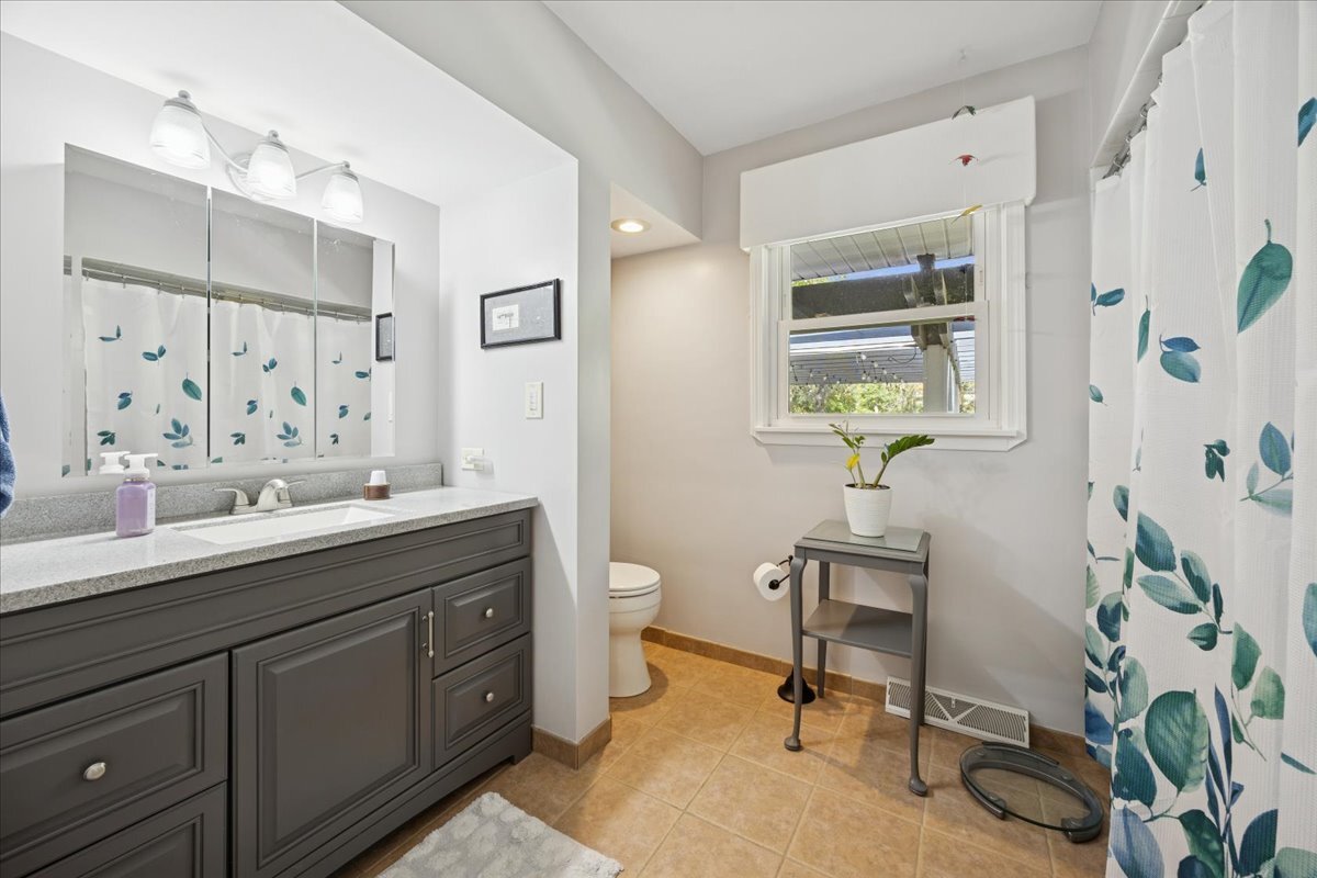 305 Poplar Lane New Lenox, IL 60451 - Photo 15 of 23 a spacious bathroom with a granite countertop sink a toilet and a mirror