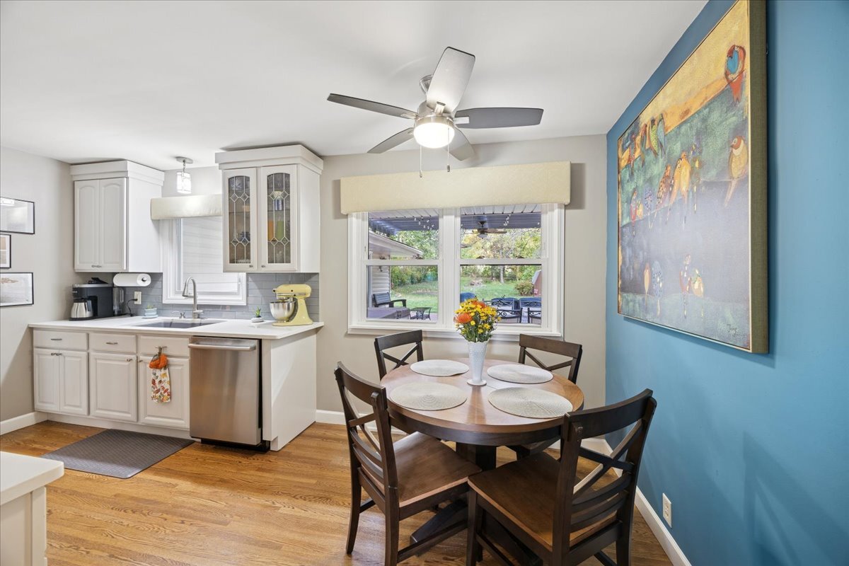305 Poplar Lane New Lenox, IL 60451 - Photo 5 of 23 a kitchen with a dining table chairs and white cabinets