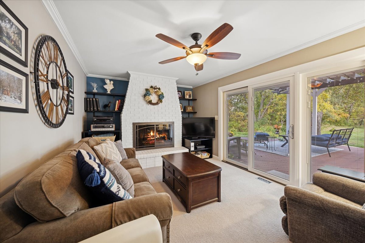 305 Poplar Lane New Lenox, IL 60451 - Photo 9 of 23 a living room with furniture a fireplace and a large window