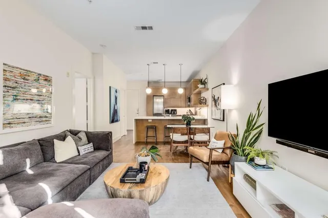 a living room with furniture and kitchen view