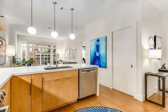 a living room with furniture a flat screen tv and a large window